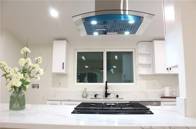 kitchen with a sink, gas stovetop, light stone counters, white cabinetry, and open shelves