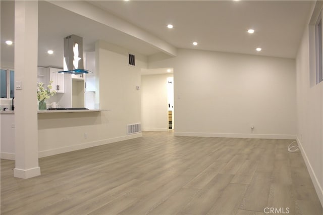 unfurnished living room featuring recessed lighting, visible vents, light wood-style flooring, and baseboards