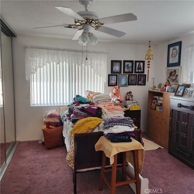 bedroom featuring a ceiling fan and carpet