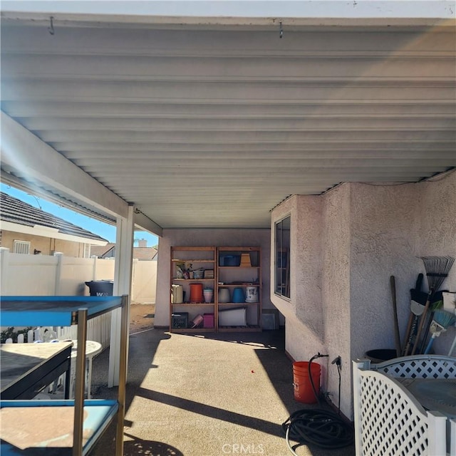 view of patio / terrace with a swimming pool and fence