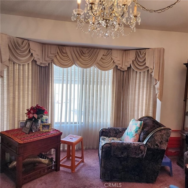 living area with carpet flooring and a notable chandelier