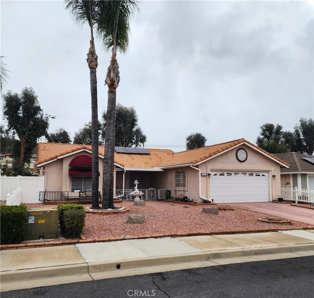 ranch-style house with a tiled roof, fence, and stucco siding