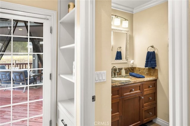 bathroom with vanity and ornamental molding