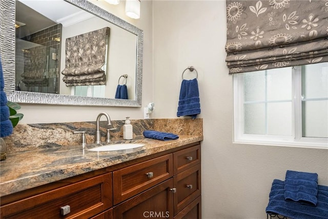 full bathroom featuring a stall shower and vanity