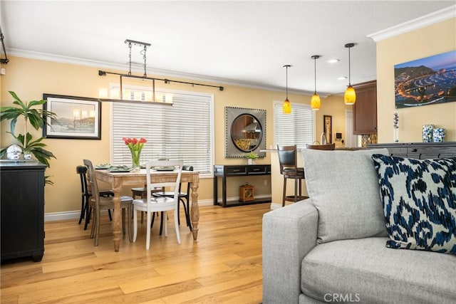 living room with recessed lighting, light wood-type flooring, baseboards, and crown molding