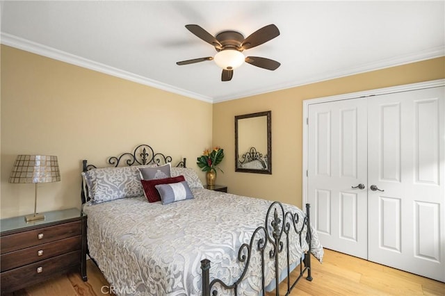 bedroom featuring a closet, crown molding, a ceiling fan, and wood finished floors