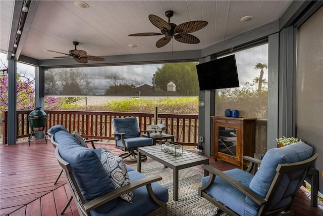 wooden terrace featuring an outdoor hangout area and a ceiling fan