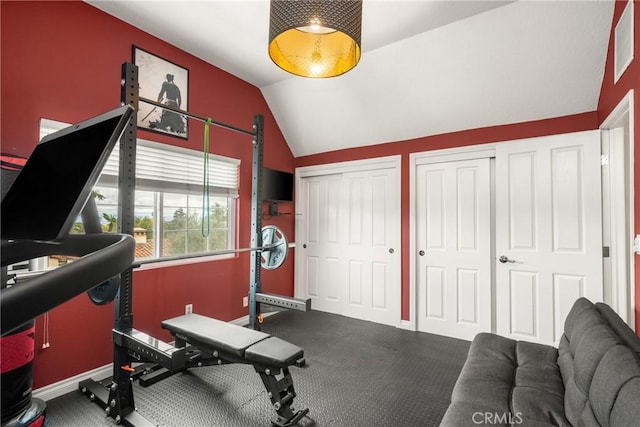 exercise area with vaulted ceiling and baseboards