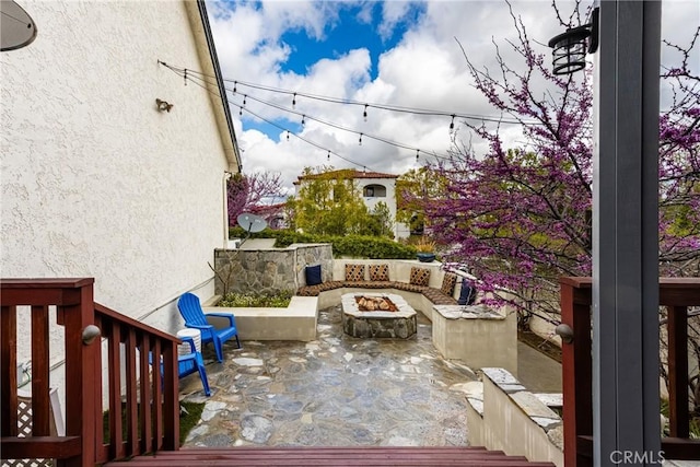 view of patio / terrace with an outdoor fire pit