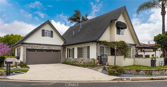 view of front of home featuring a shingled roof, stone siding, driveway, and stucco siding