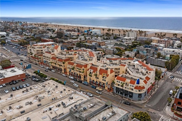 drone / aerial view featuring a water view and a view of the beach