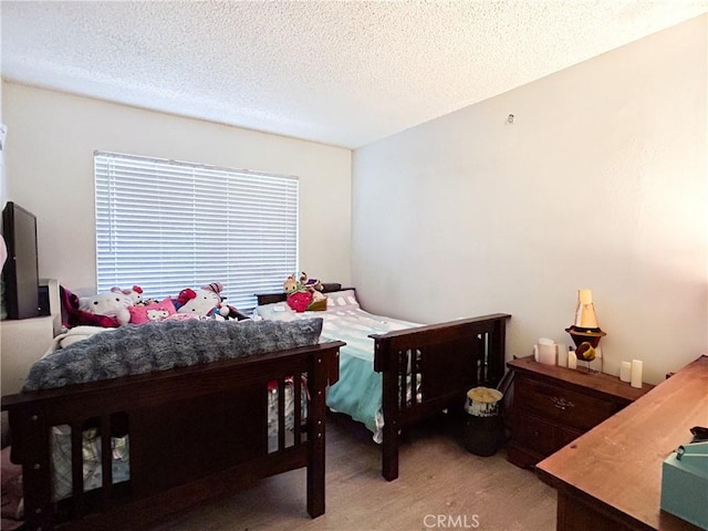 bedroom featuring a textured ceiling and carpet