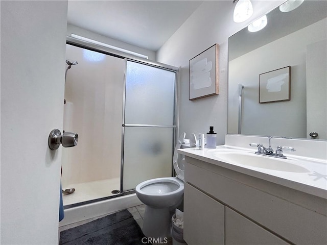 full bath with tile patterned flooring, toilet, vanity, and a stall shower