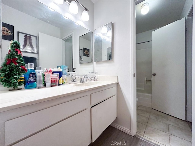 full bath with tile patterned floors, vanity, and  shower combination