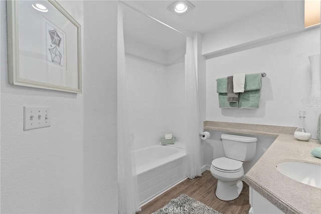 bathroom with bathing tub / shower combination, toilet, wood finished floors, and vanity