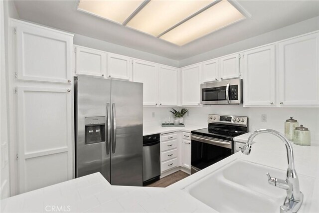 259 Chesterfield, Newport Beach, CA 92660 - kitchen with stainless steel appliances, light countertops, and white cabinetry