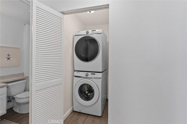 259 Chesterfield, Newport Beach, CA 92660 - laundry area featuring stacked washer / dryer and wood finished floors