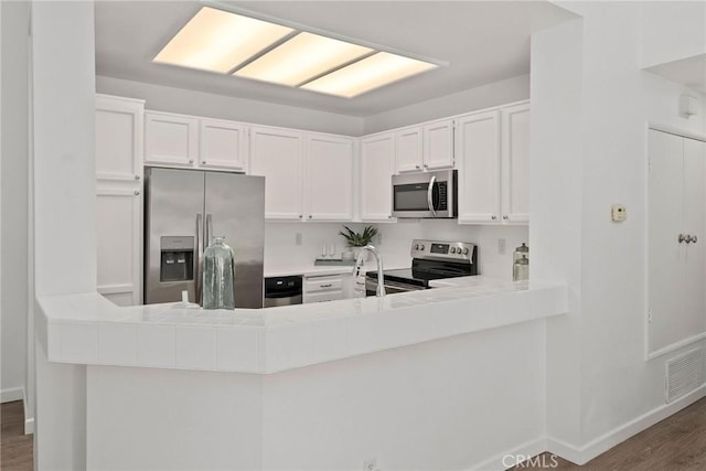 259 Chesterfield, Newport Beach, CA 92660 - kitchen featuring appliances with stainless steel finishes, wood finished floors, white cabinetry, and baseboards
