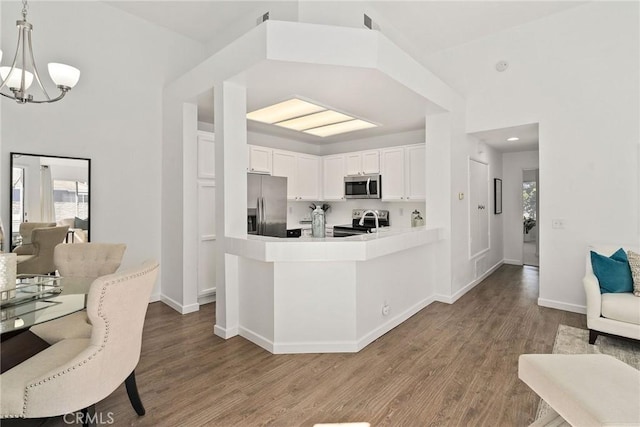 259 Chesterfield, Newport Beach, CA 92660 - kitchen with stainless steel appliances, a chandelier, open floor plan, wood finished floors, and white cabinetry