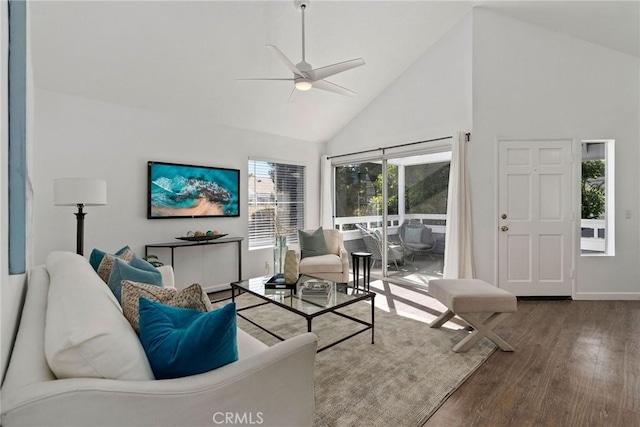 living area with a ceiling fan, wood finished floors, baseboards, and high vaulted ceiling