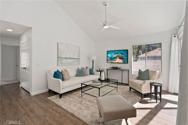 living room featuring baseboards, high vaulted ceiling, a ceiling fan, and wood finished floors