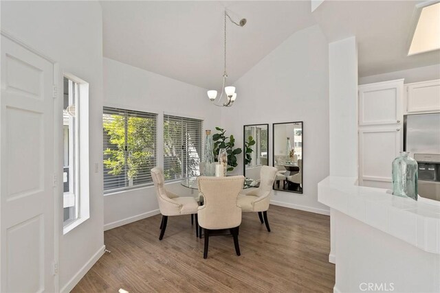 259 Chesterfield, Newport Beach, CA 92660 - dining room with a chandelier, high vaulted ceiling, and wood finished floors