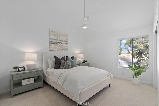 bedroom with baseboards, carpet floors, lofted ceiling, and a ceiling fan