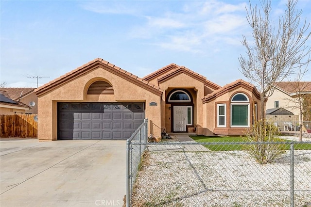 view of front of property with a fenced front yard, concrete driveway, an attached garage, and stucco siding