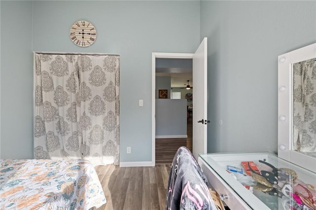 bedroom featuring baseboards and wood finished floors