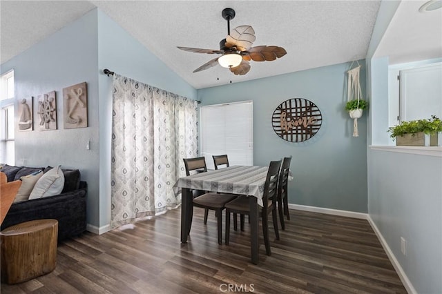 dining area featuring a ceiling fan, wood finished floors, baseboards, lofted ceiling, and a textured ceiling