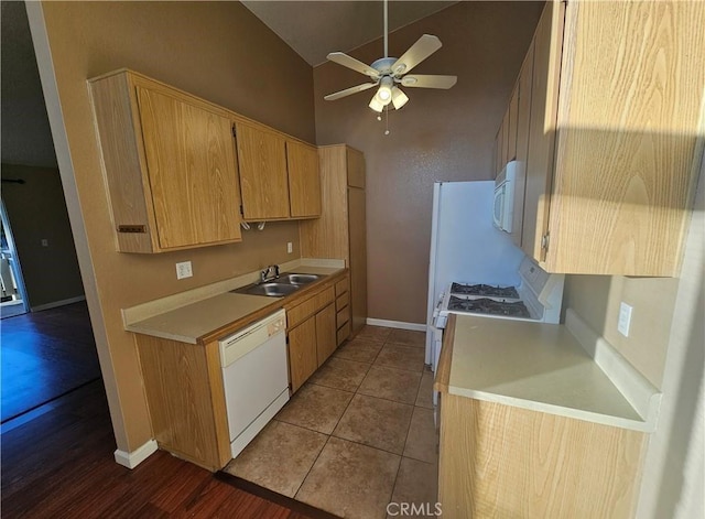 kitchen featuring a sink, white appliances, tile patterned flooring, ceiling fan, and light countertops