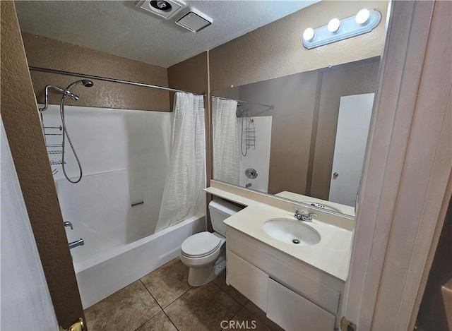 full bathroom featuring vanity, shower / bathtub combination with curtain, tile patterned floors, toilet, and a textured wall