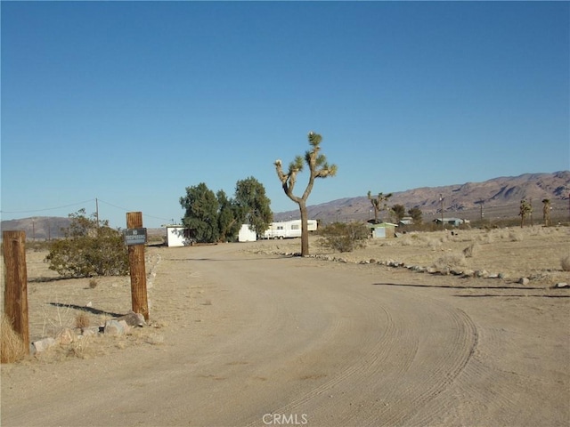 view of road with a mountain view and driveway