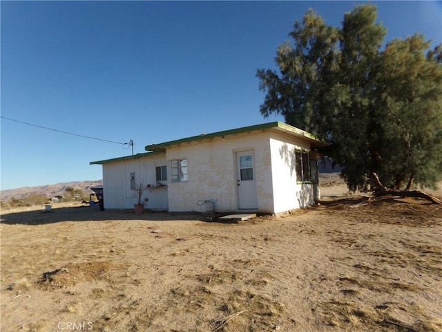 view of side of home with stucco siding