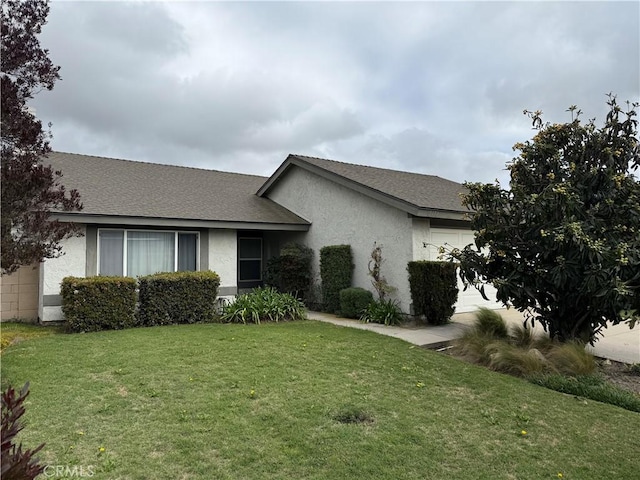 ranch-style home featuring a front lawn, a garage, roof with shingles, and stucco siding