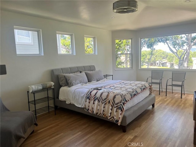 bedroom with wood finished floors and baseboards