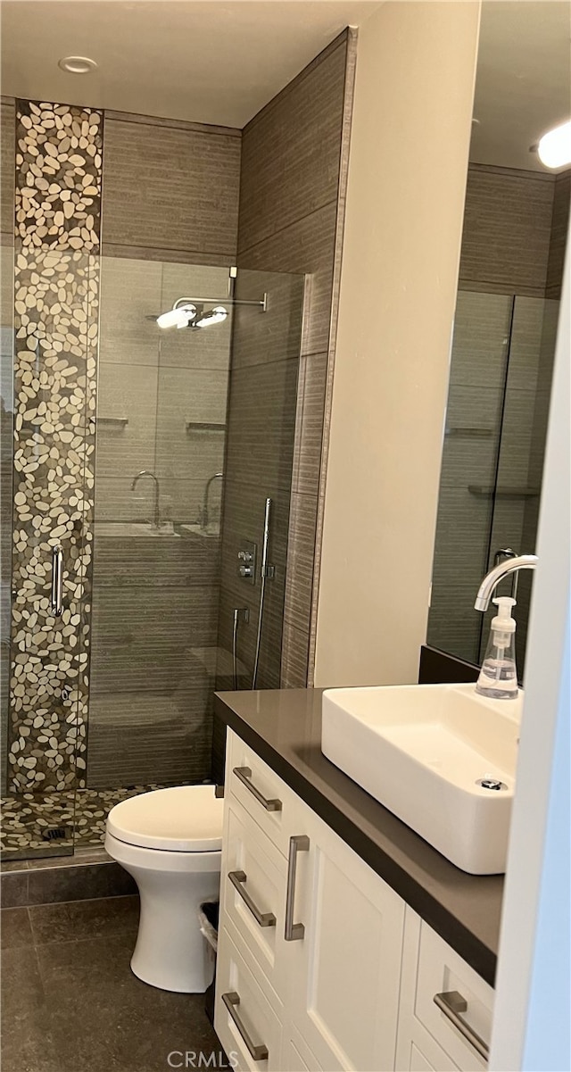 full bath featuring a stall shower, toilet, tile patterned flooring, and vanity