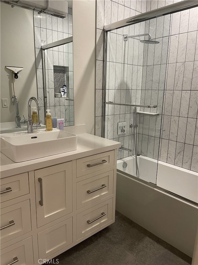 full bath featuring vanity and combined bath / shower with glass door