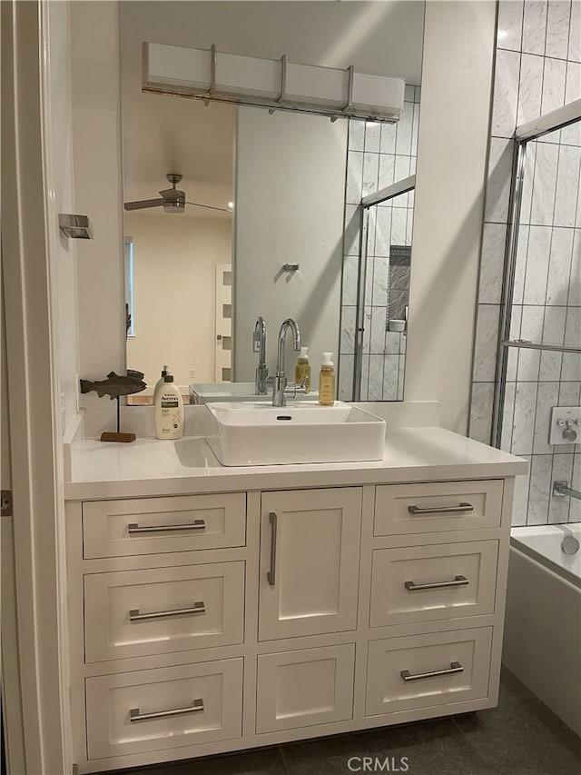 bathroom featuring vanity, bathtub / shower combination, and a ceiling fan