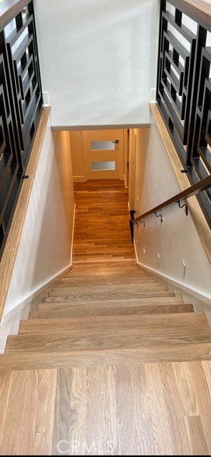 stairs featuring wood finished floors