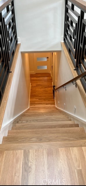 staircase featuring wood finished floors