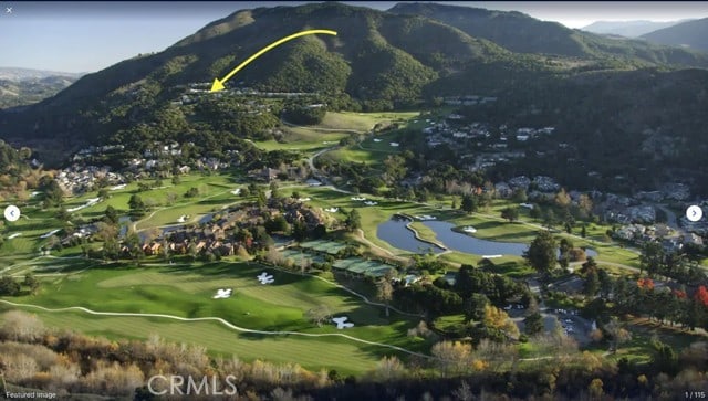 view of home's community with a water and mountain view and golf course view