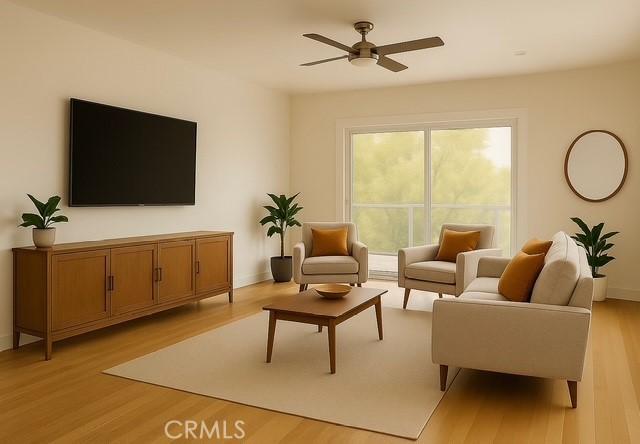 living room featuring ceiling fan, baseboards, and light wood-type flooring