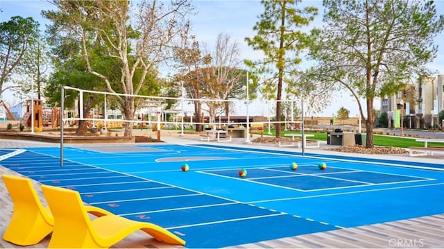 view of sport court featuring playground community