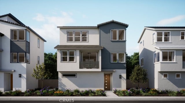 view of front facade featuring a balcony and stucco siding