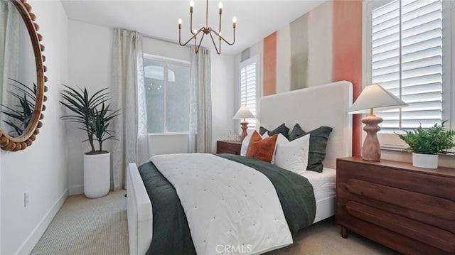 carpeted bedroom with baseboards, multiple windows, and a notable chandelier