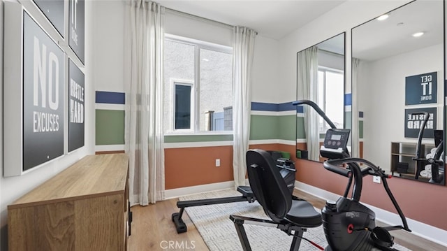 workout area with wood finished floors and baseboards