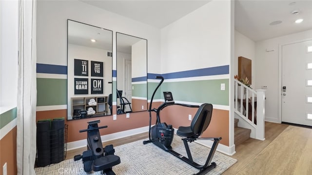 exercise area with recessed lighting, baseboards, and wood finished floors