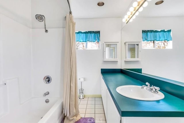 full bathroom with plenty of natural light, shower / tub combo with curtain, vanity, and tile patterned flooring