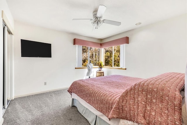 carpeted bedroom featuring a closet, ceiling fan, and baseboards